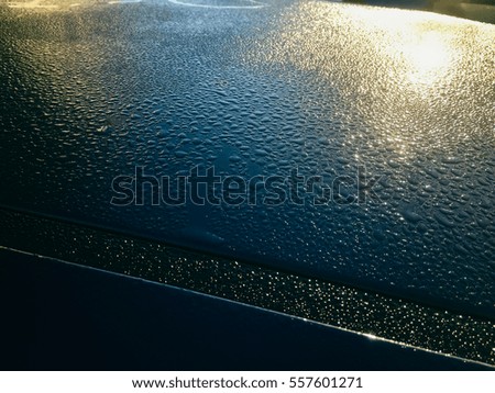 Blurred drops of rain on copyspace surface background, closeup picture