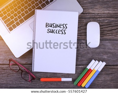  Notebook writing Business Success, Office table with laptop ,coffee cup,glasses