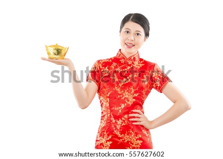 happy woman presenting golden ingot for chinese new year mean get rich and luck. isolated on white background. mixed race asian model.