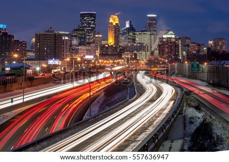 Heavy traffic flowing into Minneapolis on a busy winter evening.