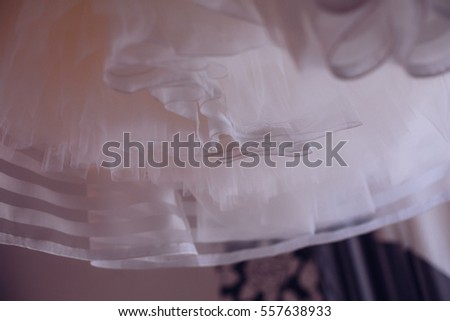 wedding dress hanging on luster at hotel room