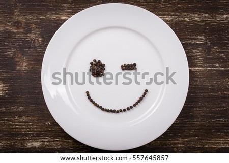 Happy smiley face on dish white plate, close up