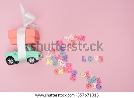 Vanlentine's day concept. Wooden letters word love and red heart  and car vintage on wood background with copy space.