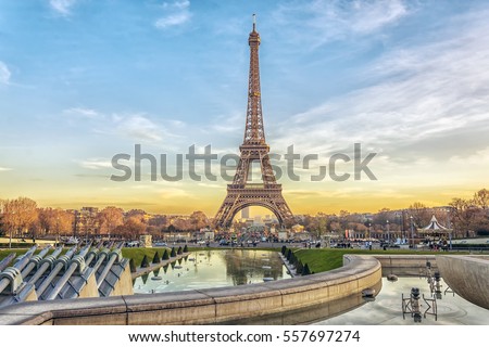 Eiffel Tower at sunset in Paris, France. Romantic travel background. Royalty-Free Stock Photo #557697274