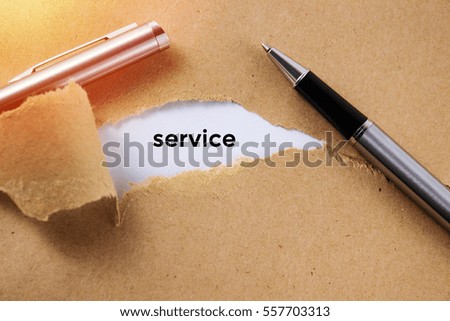 The word Service appearing behind torn paper with pen was opened