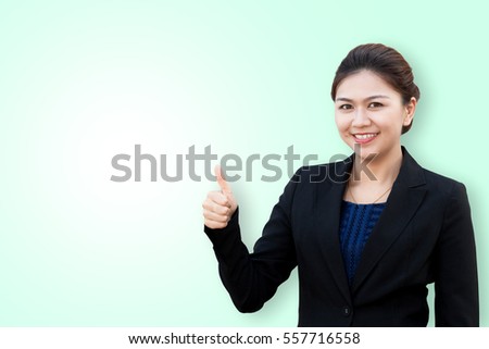 Business woman showing thumbs up smiling isolated on green background