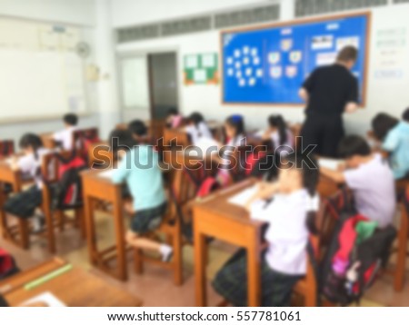 Blur kids and teacher in the computer classroom for background usage.