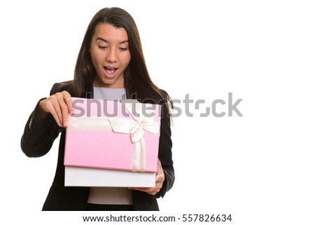 Young happy Caucasian businesswoman smiling and opening gift box isolated against white background