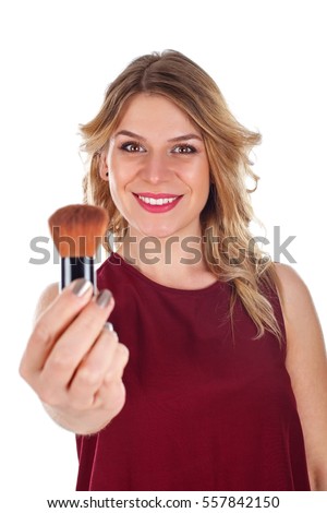 Picture of a beautiful young lady holding a make-up brush