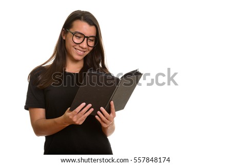 Young happy Caucasian woman smiling and reading book isolated against white background