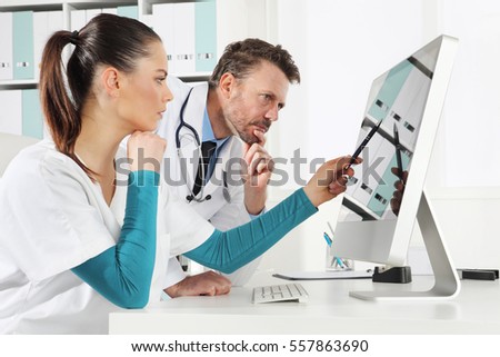 Doctor use the computer with nurse, concept of medical consulting
