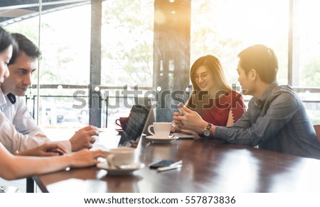 4 people meeting in coffee shop, business casual conceptual