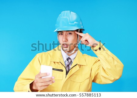 Asian worker in an uneasy look