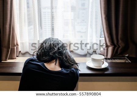 Sleepy woman at the window
