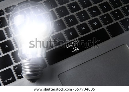 Bulb and black keyboard with innovation and strategic conceptual words. 