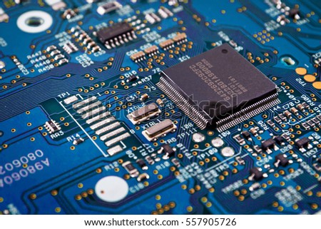 Blue system board with microchips and transistors Royalty-Free Stock Photo #557905726