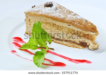 Peace of cake with strawberry topping and mint
