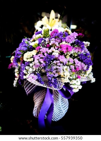 purple flower bouquet on black background, purple bouquet, flower bunch, flower arrangement in purple