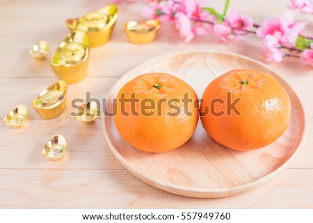 Top view accessories Chinese new year festival decorations.orange,leaf,wood dish,red packet,plum blossom, on wood background