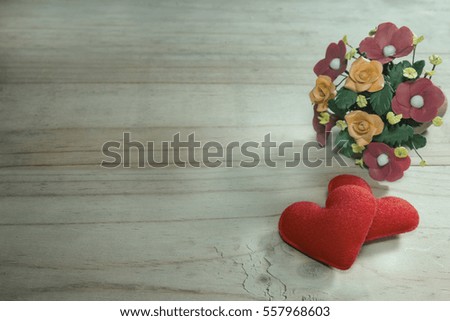 two heart-shaped with flower on wood