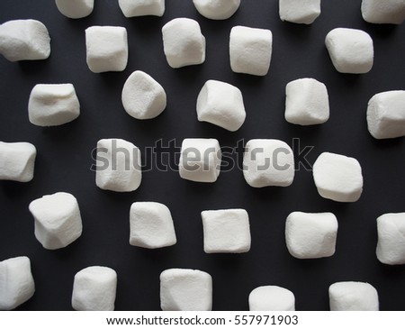 Marshmallows. Background or texture of white mini marshmallows on black background. Flat lay, top view