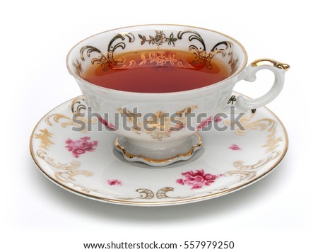 Black tea in antique tea cup isolated on white background Royalty-Free Stock Photo #557979250