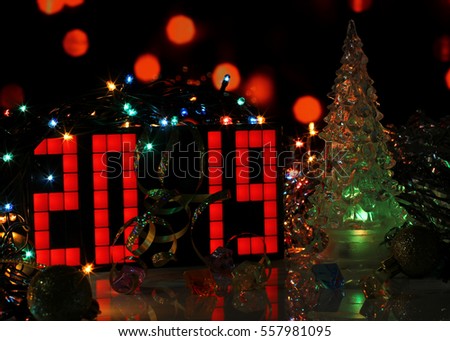 Happy New Year 2019 colorful greeting card with glass Christmas tree on dark red bokeh background. Party poster, banner or invitation. Mirror surface. Number formed from red digital clock. 