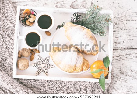 Espresso, croissants and nuts on a tray. Romantic breakfast for Valentine's Day, Birthday. Witner decor.