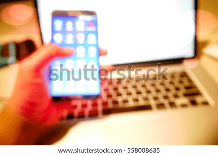 Picture blurred  for background abstract and can be illustration to article of hands using smart phone connecting to laptop