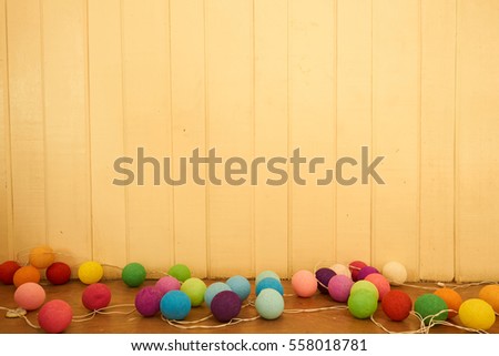                                Colorful balls and light yellow wood wall