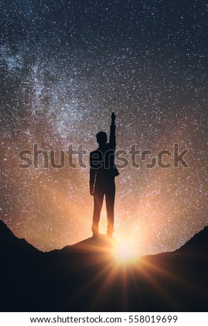 Back view of man in space reaching out for the stars. Dreams concept