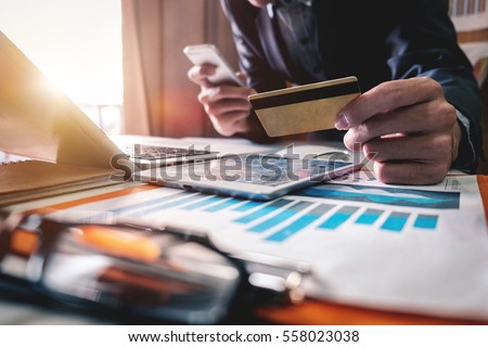 Business man hands using laptop and holding credit card with digital layer effect diagram as Online shopping concept

