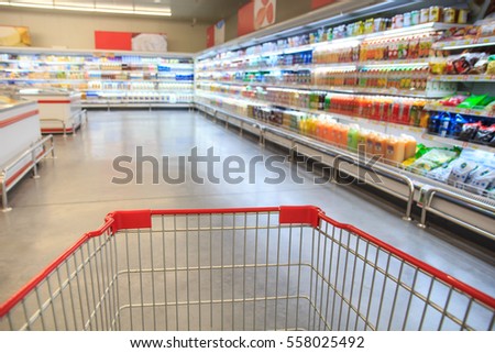 Defocused blur of supermarket cart with dairy products. Blur background with bokeh. Defocused image Royalty-Free Stock Photo #558025492