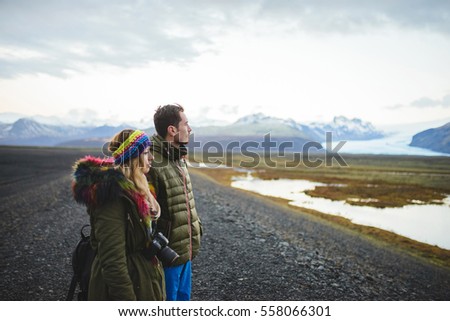 couple looking at lake and mountains in Iceland