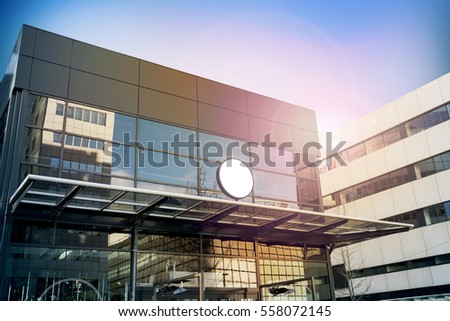 Blank white round signage mockup, modern business building. Circle sign board mock up hanging on glass roof of the store endrance. Street advertising banner design template.
