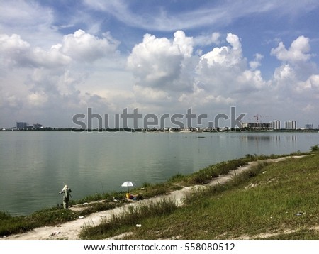 view of a lake with fisherman in selangor, malaysia