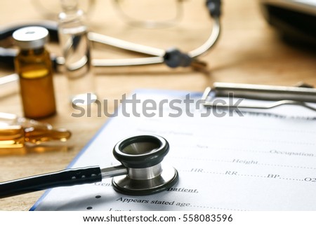 Selective focus Health care concept. Stethoscope on a medical chart with Drugs and Eyeglasses.