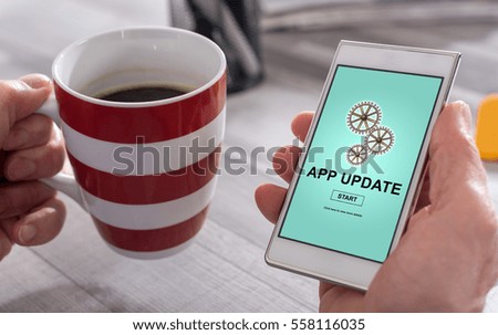 Male hand holding a smartphone with application update concept
