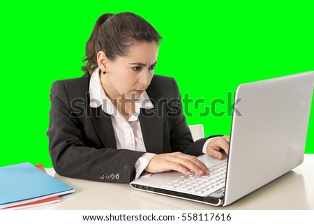 overworked hispanic business woman wearing business suit working on laptop computer looking stressed and worried in woman facing work problem concept isolated on green chroma key screen background