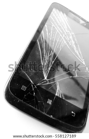 Mobile smartphone with broken screen isolated on white.