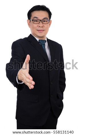 Smiling Asian Chinese man wearing suit posing with handshake gesture in isolated white background.