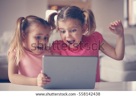 The girls watched something on tablet.