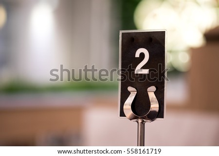 Table number two with copy space. abstract. selective focus Royalty-Free Stock Photo #558161719