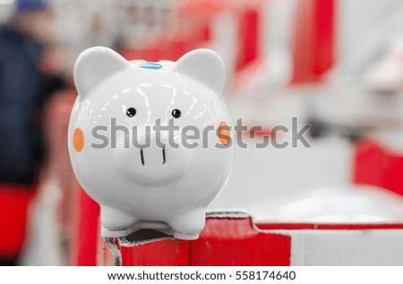 little pig piggy bank on top of a supermarket