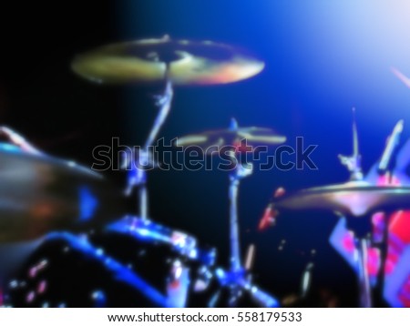 abstract blurred image. Actor drummer plays the drums. Musician plays a musical instrument on the concert stage                               