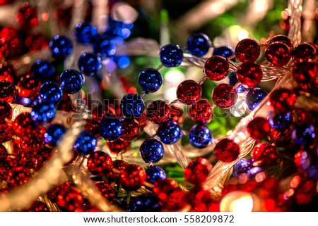 Abstract, blurry, vibrant and colorful background. A shot of Christmas decorations and lights on a lit Christmas Tree. Celebrations, holidays, family together, warmth in hearts. Champagne and lights.