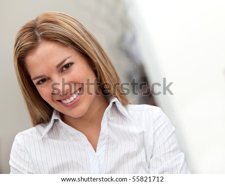 Beautiful business woman portrait smiling at the office