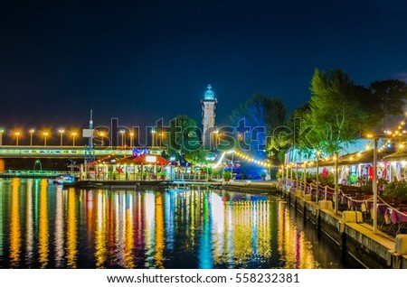 Night view of restaurants on the shore of donau river near VIC and Donauturm in Vienna, Austria.