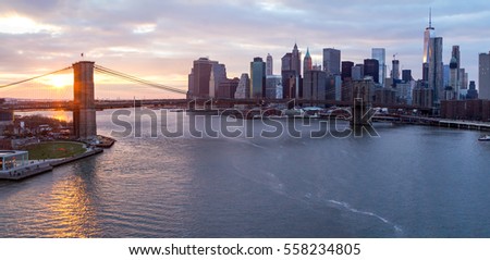 New York City panorama landscape scene at sunset with Brooklyn Bridge over the East River and Lower Manhattan skyline skyscrapers