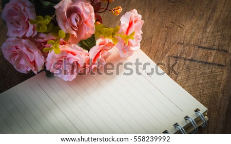 Artificial roses and brown paper with word LOVE FOREVER